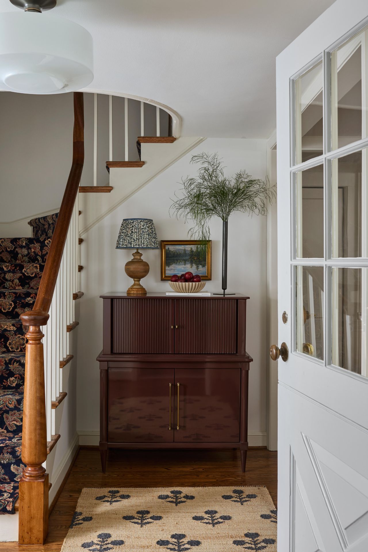 Entryway with stairs, a rug + antique furniture is exactly what makes a Washington DC home feel collected rather than overdesigned